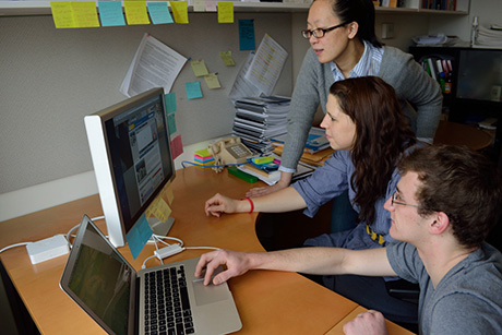 Ying Hua, Assistant Professor in DEA, discussing energy dashboard research with her two student assistants.