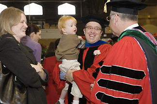 Brandon Lee with son and wife and President Skorton