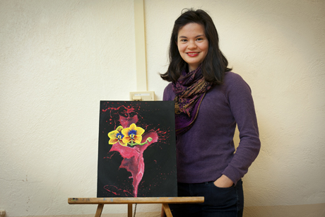 Meghan Witherow '14 with art she created for the exhibit "We Step Into the Light Ithaca 2013."