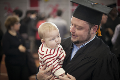 graduate holds baby