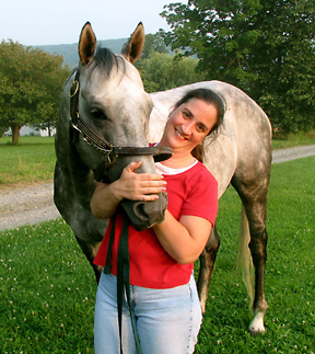 Former racehorse Watchmon nuzzles his owner