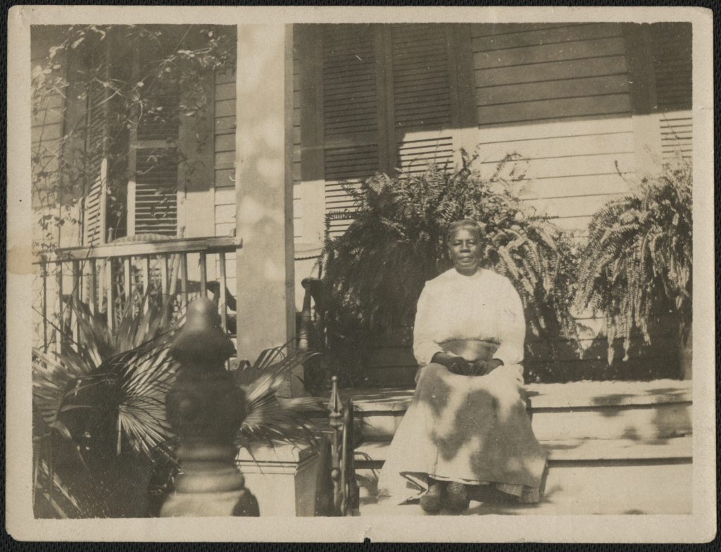 Woman sitting on porch with plants