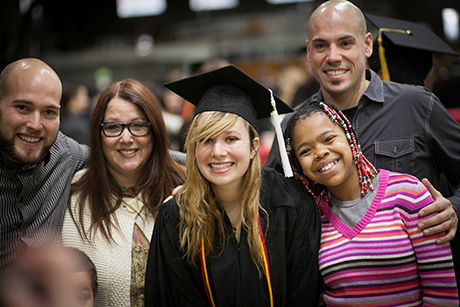 graduate with family and friends