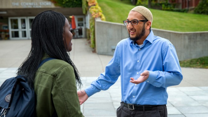 Ahmed speaks with student