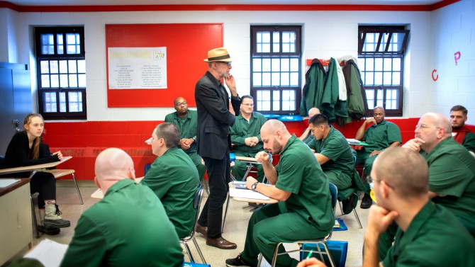 A professor teaches students in a prison