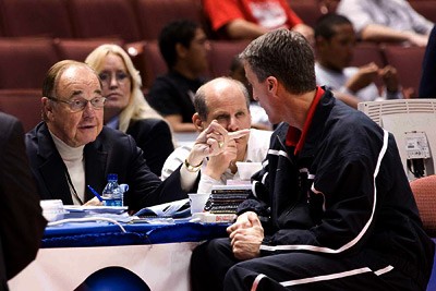 Steve Donahue, right, Cornell men's basketball coach, debriefs CBS play-by-play announcer Dick Enberg
