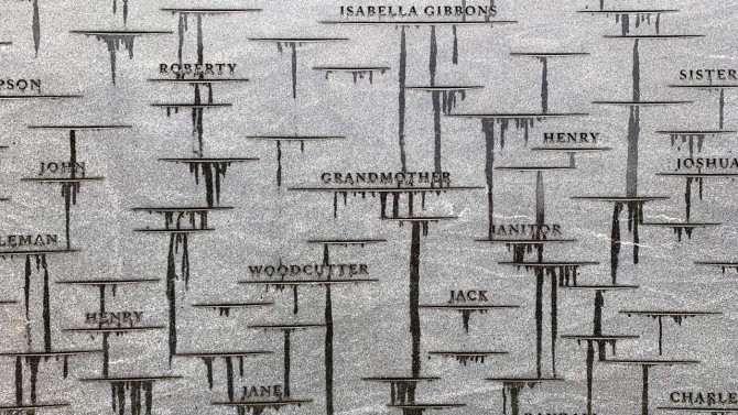 A close-up of the inner wall of the Memorial to Enslaved Laborers, with names and memory marks honoring members of the University of Virginia’s enslaved community, after a rain shower.