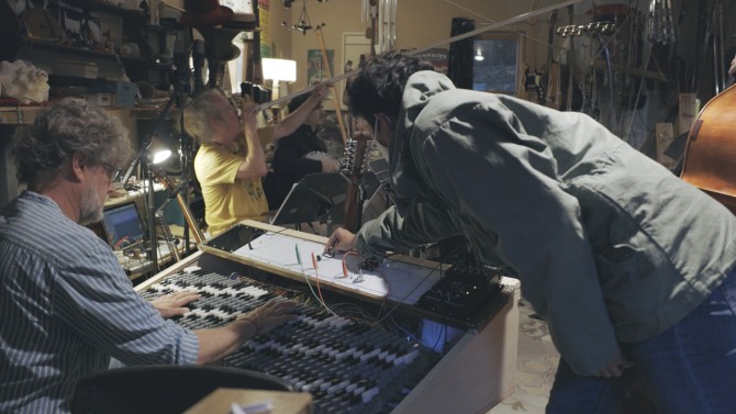 People adjusting instruments in music studio