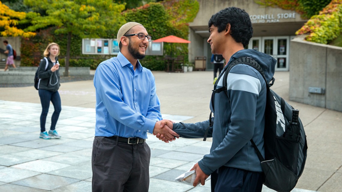 Yasin Ahmed greets student