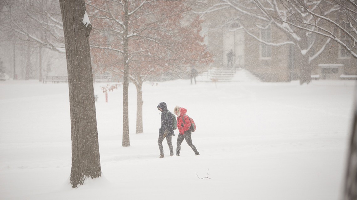 Students walk through the Arts Quad during a winter storm in March 2017 that closed Cornell.
