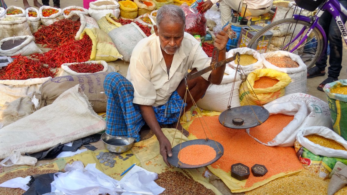 Man weighing lentils