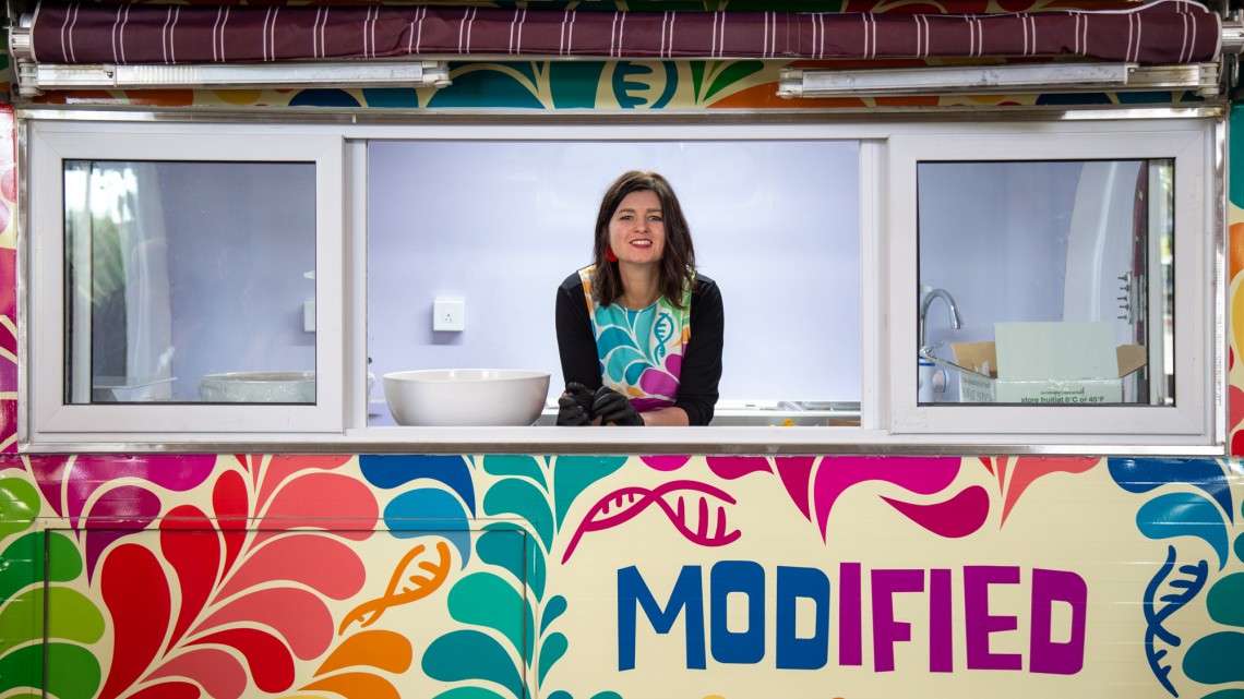 Sarah Evanega behind the window of a colorful food truck