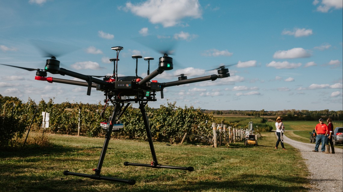 image of a drone flying over crops