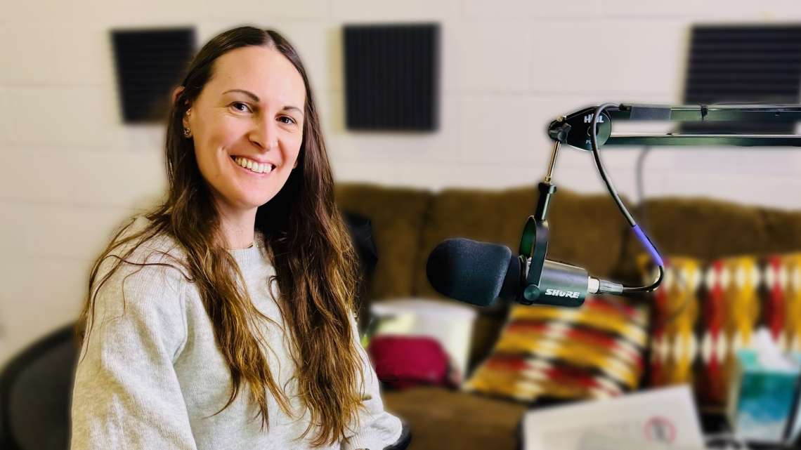 Lauren Frederick smiling in front of microphone in studio