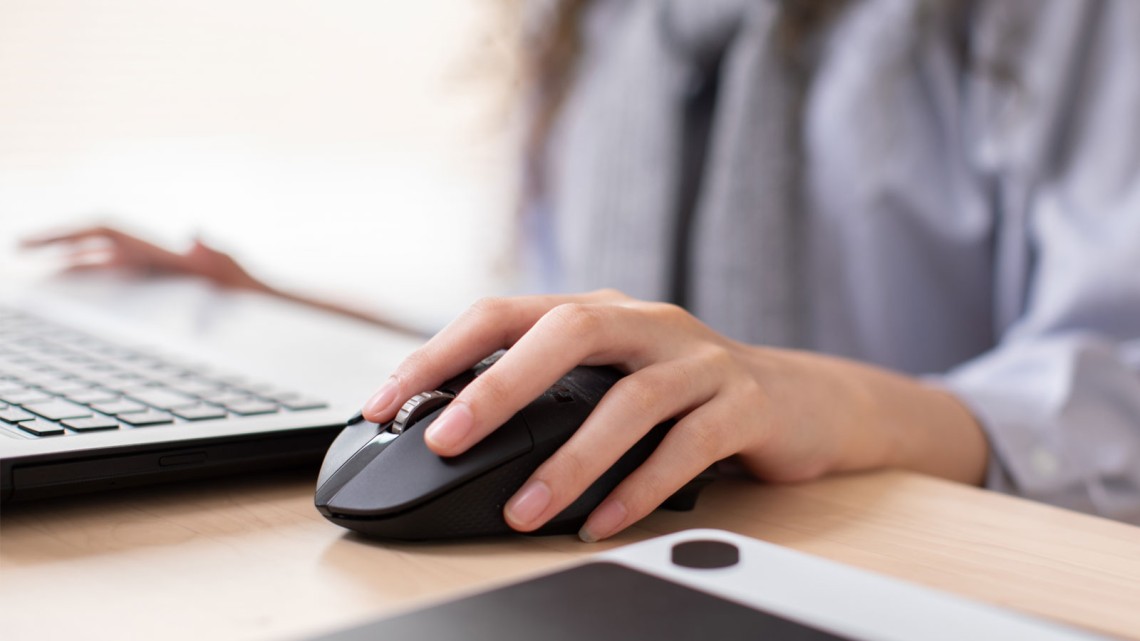 Image of a woman's hand using a computer mouse
