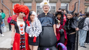 Students in costume pose for a picture. 