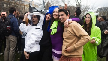 Students in costume pose for a picture on the Arts Quad. 
