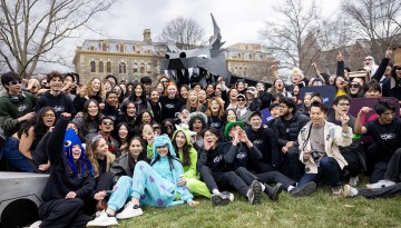 Group photo in front of the dragon on the Arts Quad.