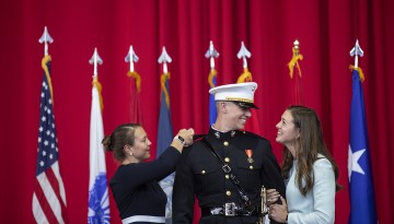 ROTC Cadet is pinned by family members. 