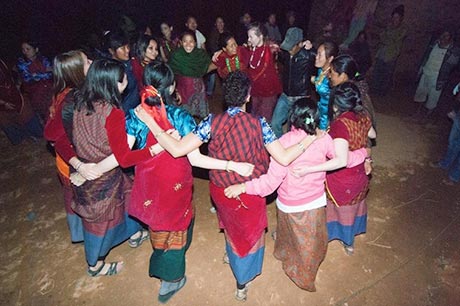 Students dance with Nepalese villagers