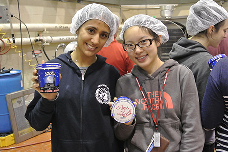 students hold up a pint of ice cream