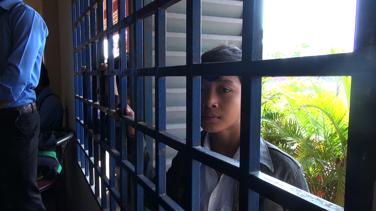 Boy in barred window
