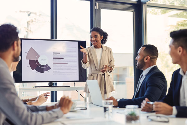 Business meeting presentation with a woman presenting to her colleagues