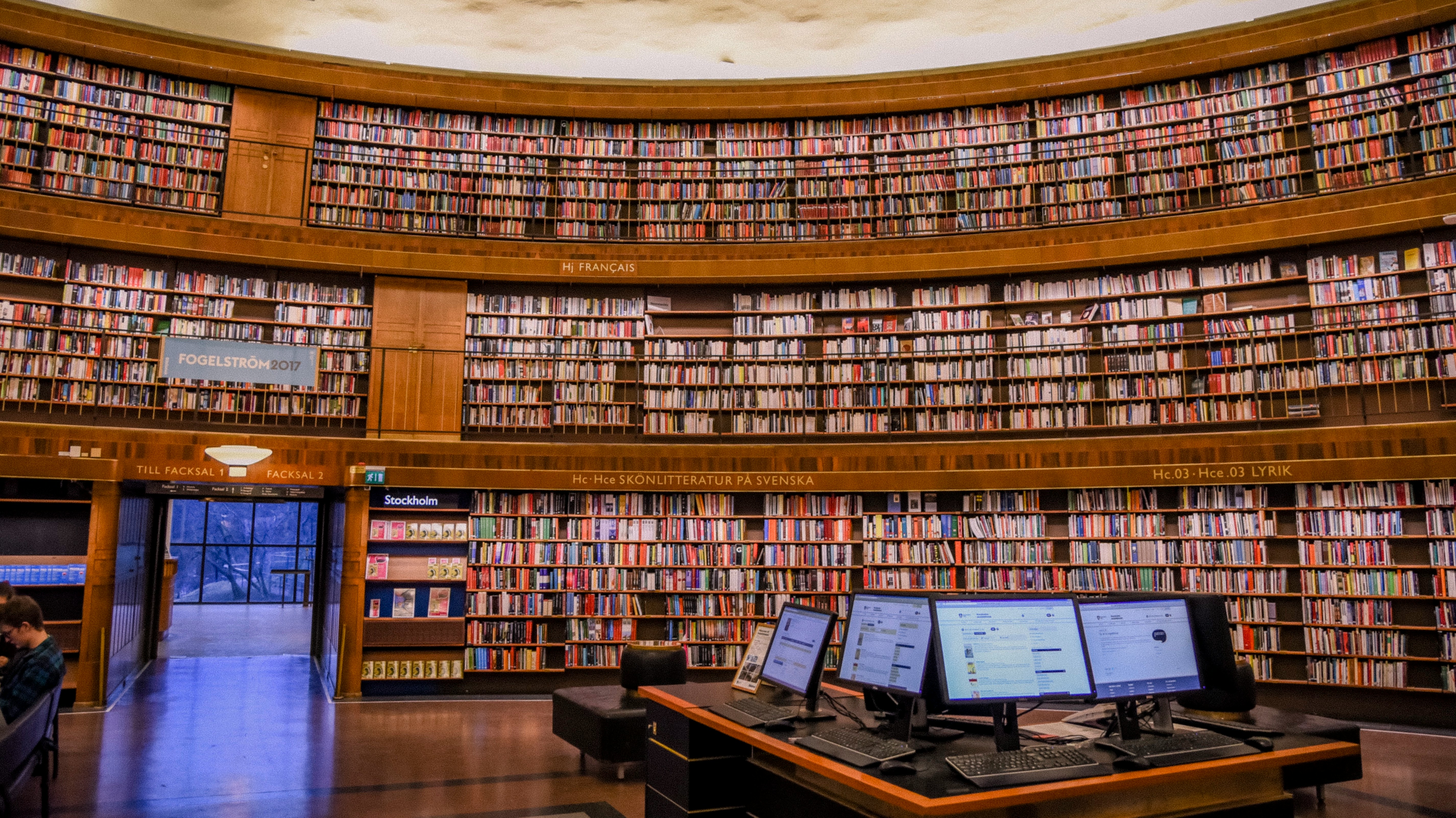 library with computers on a table in the center