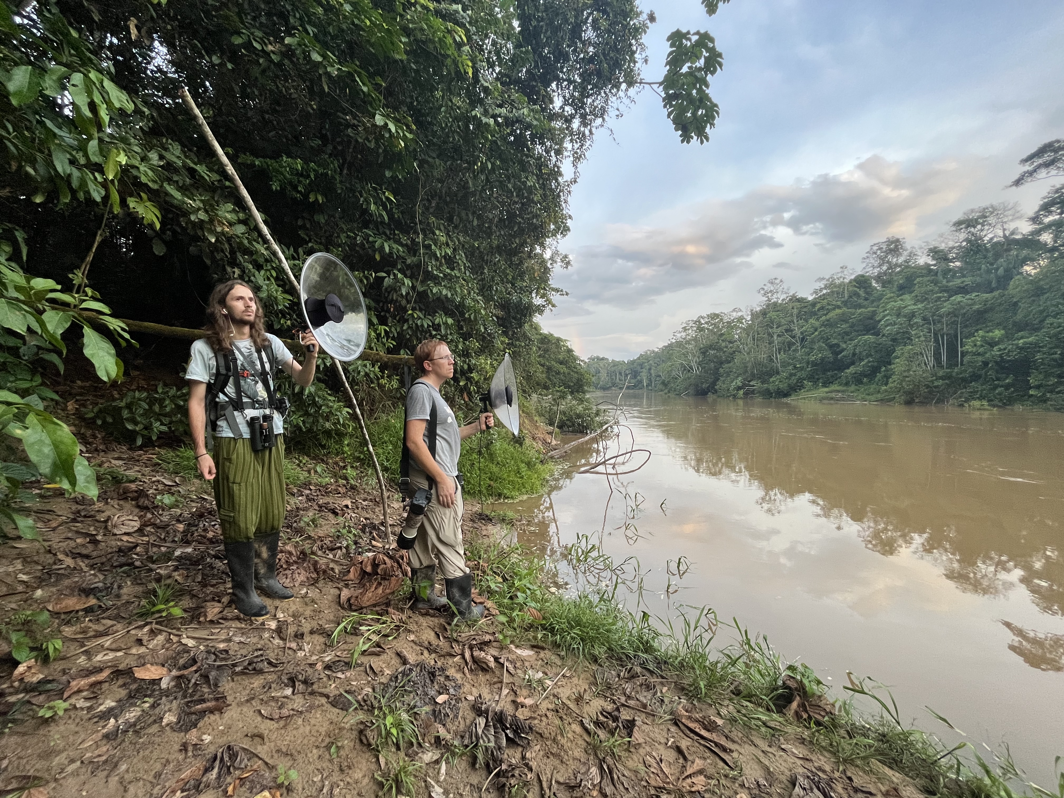 Researchers in Ecuador hold up tools to record bird sounds in Ecuador.