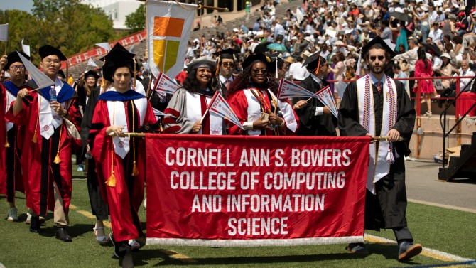 Kavita Bala, dean of the Cornell Ann S. Bowers College of Computing and Information Science, fourth from right, with students at Commencement in 2023. Bowers 2020 gift established the college that now bears her name.