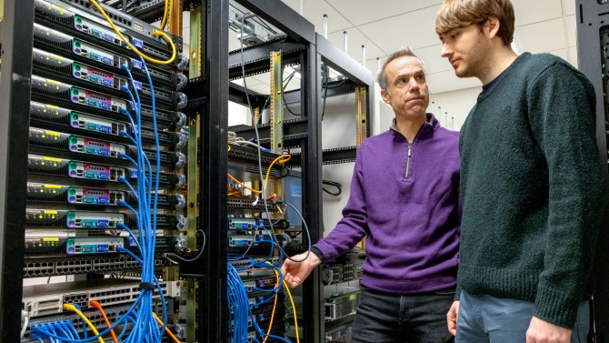 Peter Wittich (left), Cornell faculty and lead researcher on the IRIS-HEP project, and graduate student Gavin Niendorf, inspecting a server rack destined for use at the CMS detector.
