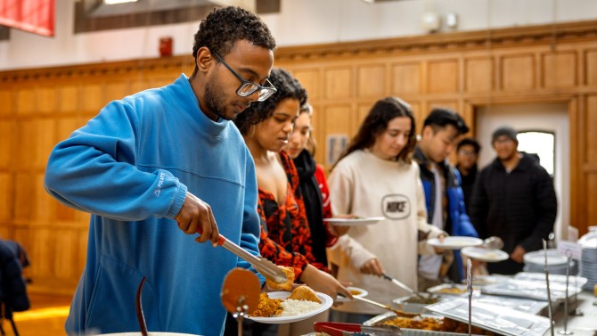 Awadalla and other students get food at the Feast for Peace on Feb. 15.