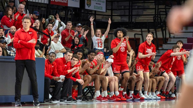 Head Coach Brian Earl (left) looks on as players on the bench cheer during the Big Red’s 87-81 victory over Penn on March 1 at the Palestra.