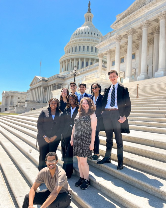 Students pose in front of the Capitol building in Washington, D.C. after speaking with lawmakers.