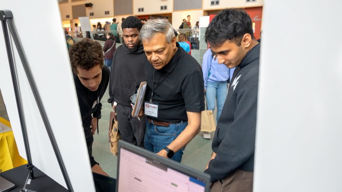Rishi Guiar, right, and Simon Ilincev, left, demonstrate their project, Cold Craft, an AI email assistant, during BOOM.
