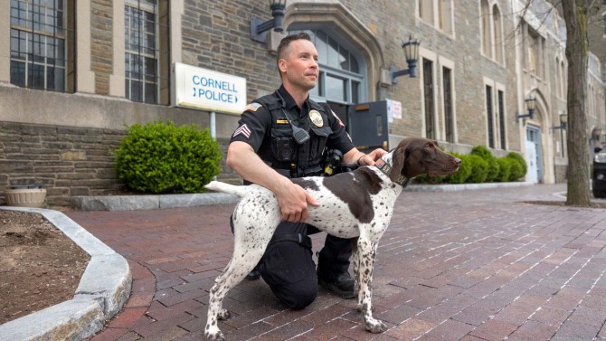 Patrol Sgt. Justin Haines with Luna outside Cornell Police headquarters at Barton Hall.