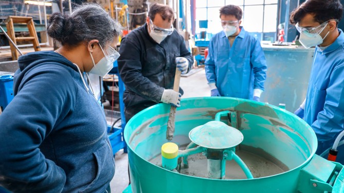 A group led by Sriramya Nair, assistant professor of civil and environmental engineering, left, prepares mortar to be 3D printed in the Bovay Lab. 