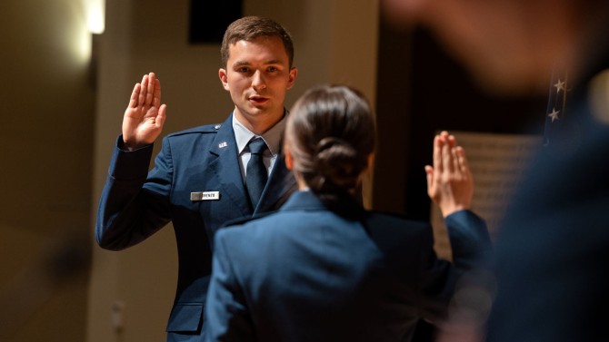 Samuel DeLorenzo is commissioned as a second lieutenant by his wife, Air Force 1st Lt. Shauna (Hwang) DeLorenzo, at the 2022 ROTC Commissioning Ceremony.