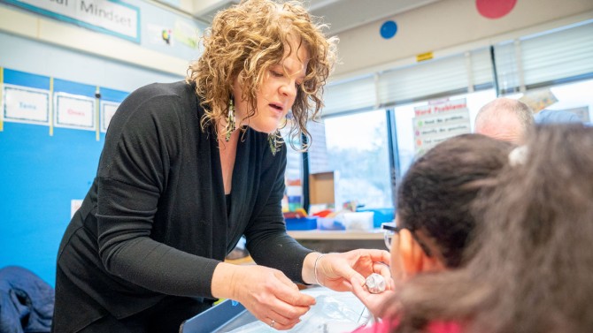 Janet Loebach, the Evalyn Edwards Milman Assistant Professor in Child Development in the College of Human Ecology, works with students at Fall Creek Elementary School.