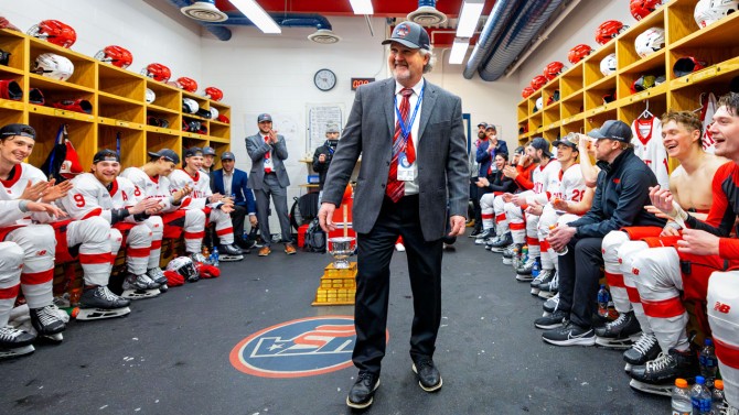 Mike Schafer celebrates the 2024 ECAC Hockey Tournament title in the locker room.