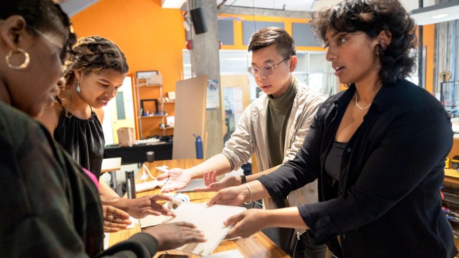 Members of the EquiPad team Bryan Wong, center right, and Sanjana Gurram, right, discuss their prototype with fellow entrepreneurs.