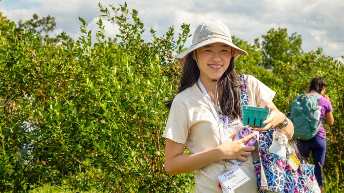 Fiona Jiang with fresh blueberries harvested from the Cornell Orchards on July 18.