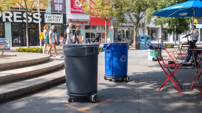 Trashbots — one for landfill waste, one for recycling — draw stares during their deployment in Albee Square, Brooklyn, in July.