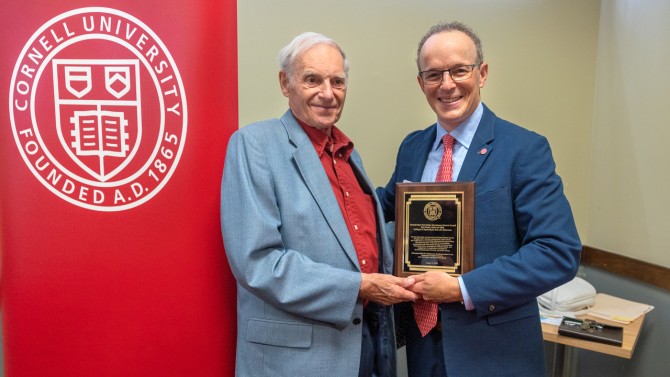 Joel Malina, right, vice president for university relations, presents Don Reed '62 with the NYS Hometown Alumni Award on Aug. 17 in Cortland.