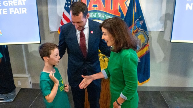 Ashton Houlton, a member of 4-H, along with his father Benjamin Houlton, dean of the College of Agriculture and Life Sciences, congratulate Gov. Kathy Hochul on receiving the 4-H Distinguished Alumni Medallion.