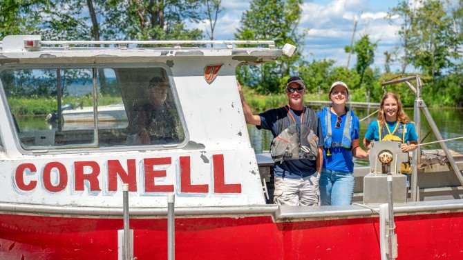 Krystal Dixon ’24 (right), spent her summer working alongside CCE and New York Sea Grant Fisheries Specialist Stacy Furgal (center) on lake sturgeon research.
