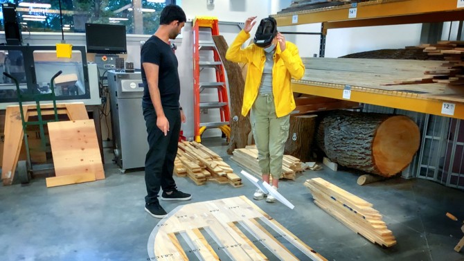 Research assistants Nina Koscica ’21, right, and Sahir Choudhary ’21 use a mixed-reality headset during the assembly of HoloWall, an installation designed by Leslie Lok’s Rural-Urban Building Innovation Lab.
