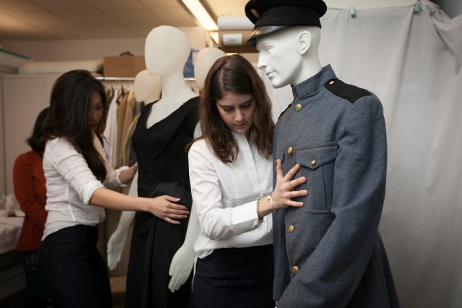 design students dress a mannequin with the Cornell Cadet Corps uniform
