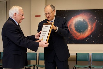 Yervant Terzian, the 2010 recipient of the Summa Bonum award for teaching excellence, receives a plaque from Crestron Electronics Inc. CEO George Feldstein in a ceremony Dec. 3.
