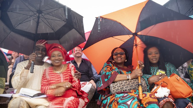 families hold umbrellas